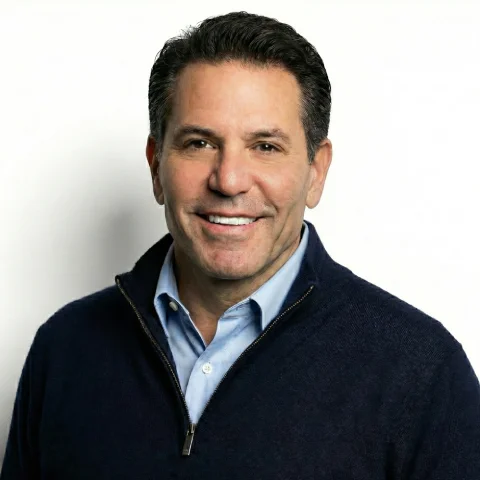 Man in a black suit and white shirt.