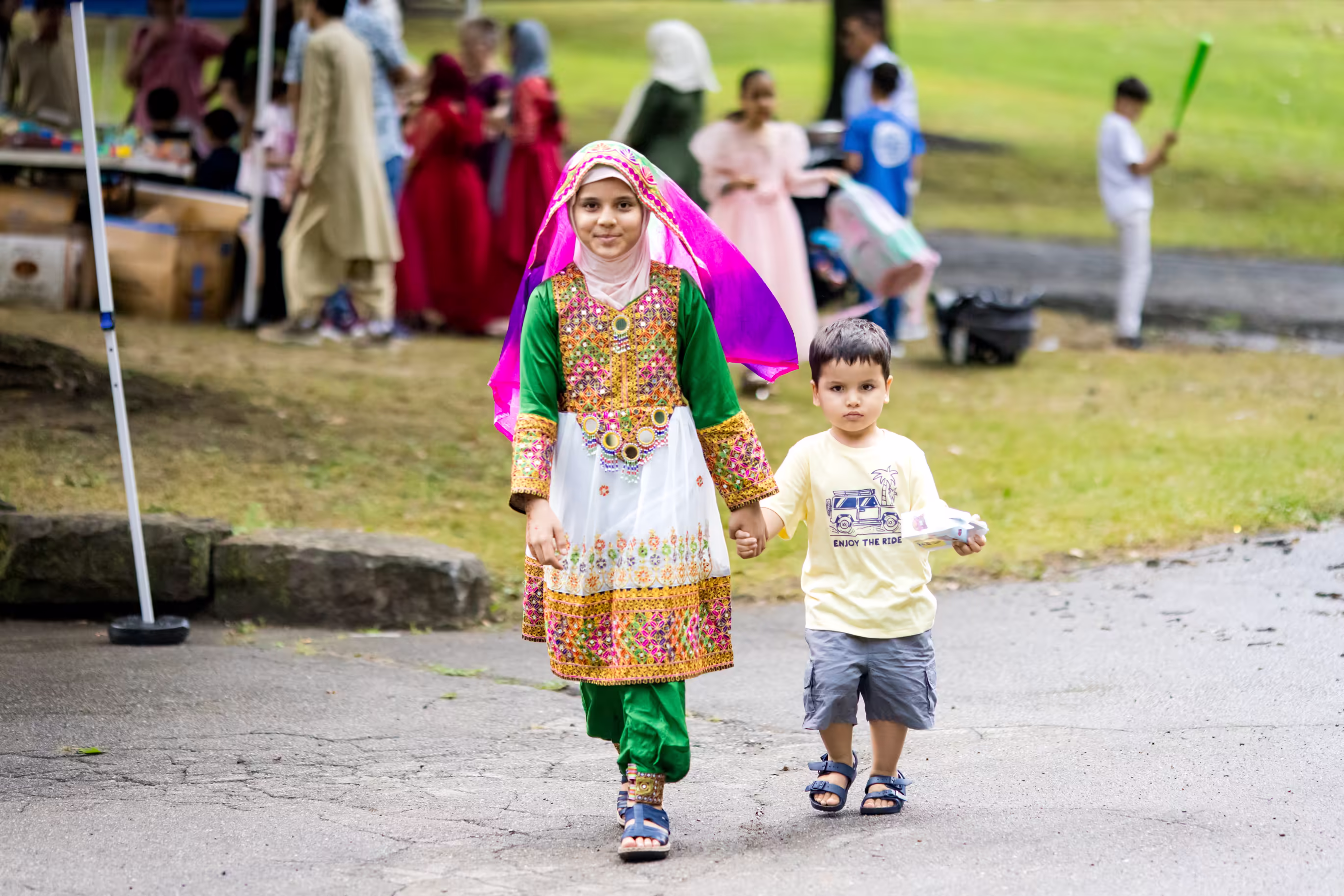 Children walking holding hands at picnic in park