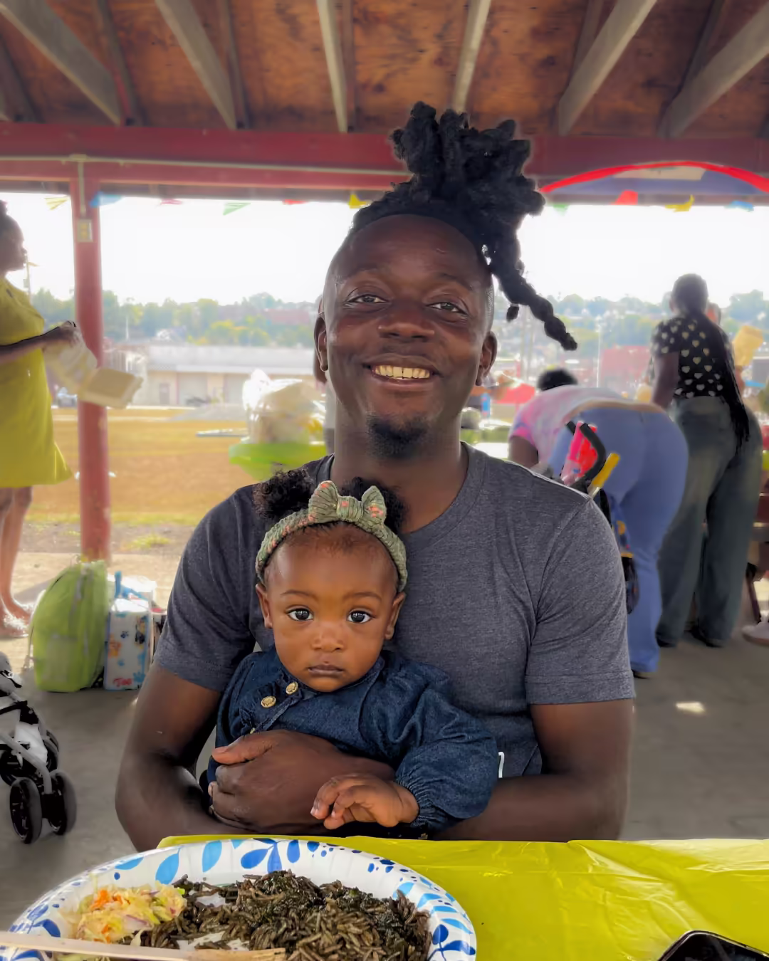 Father and daughter smiling at picnic