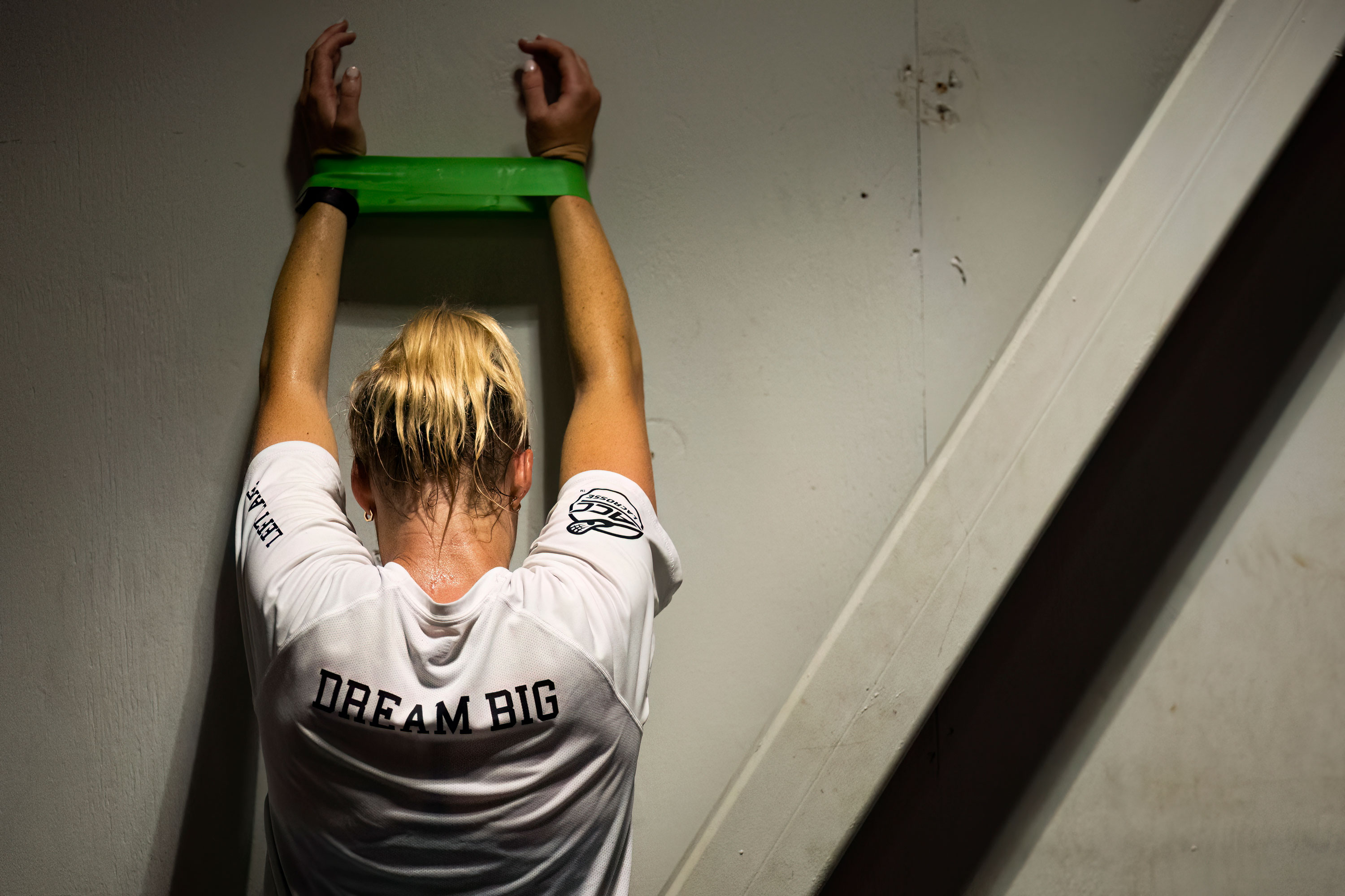 Female Athlete doing band work wearing a dream big shirt