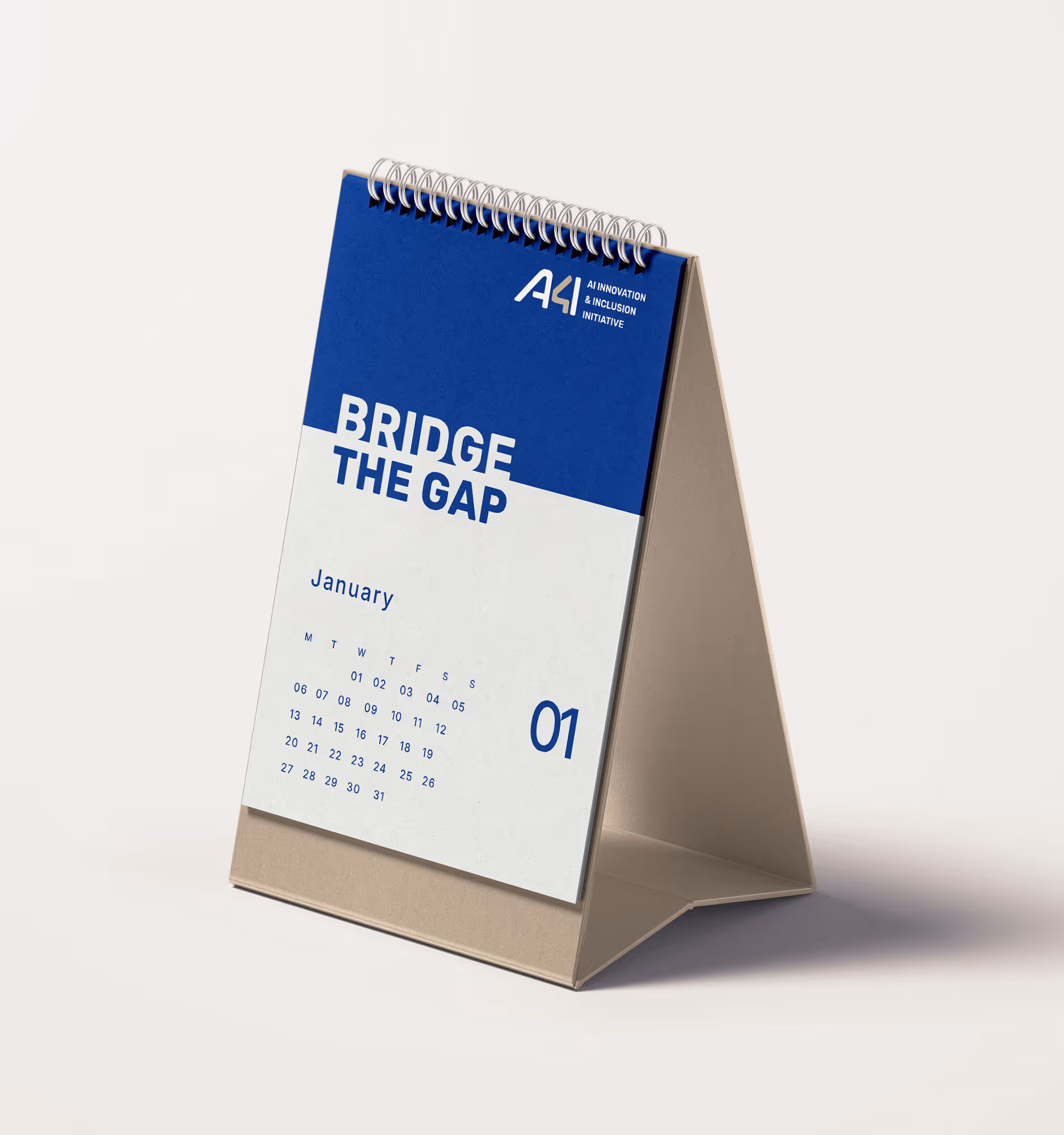 A desk calendar showing January with the text 'Bridge The Gap' and the logo for AI Innovation & Inclusion Initiative.