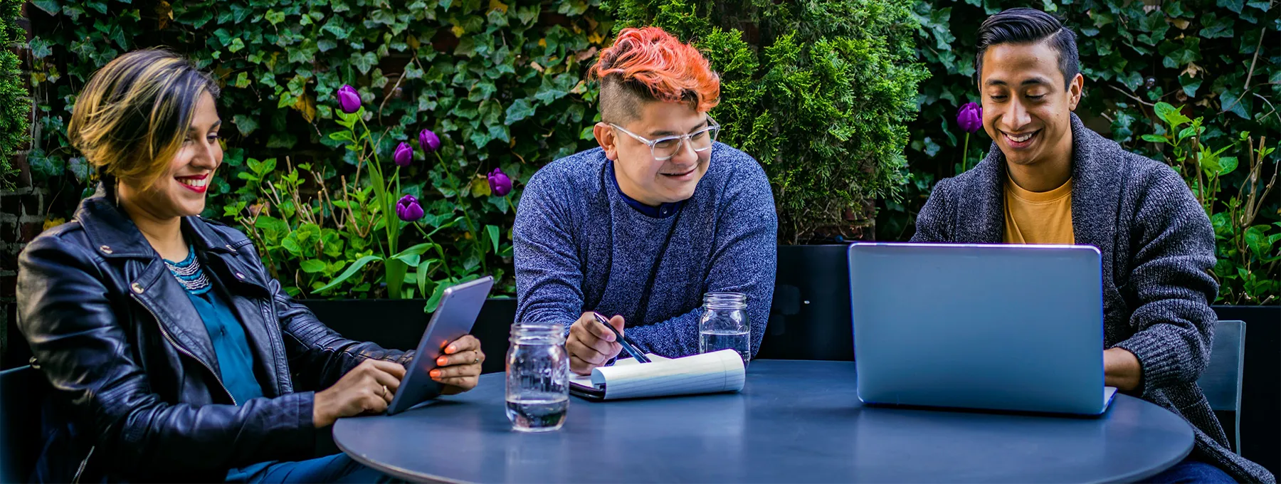 Group of marketers sitting around a desk with a designer