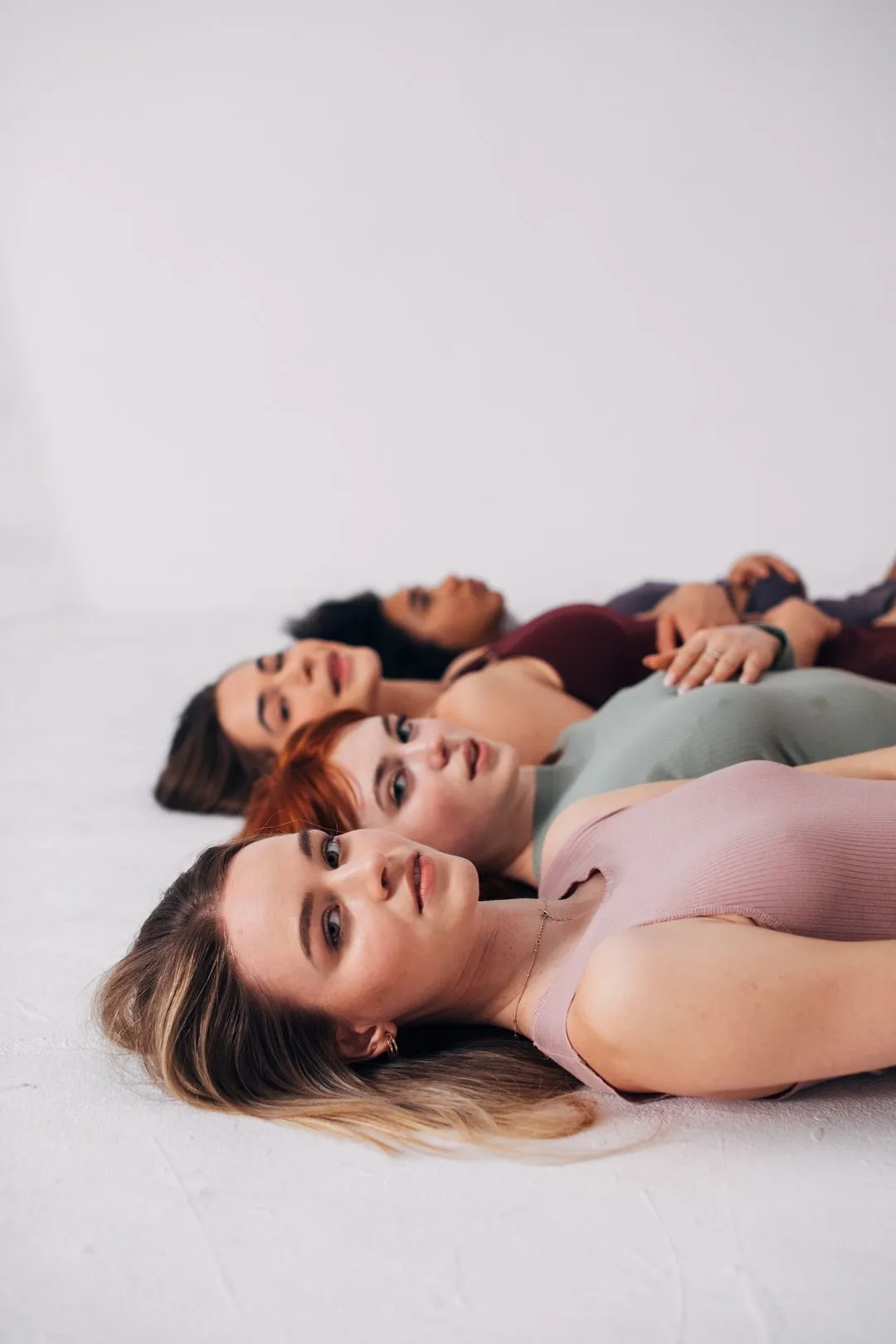 A doctor sitting at a desk across from a patient discussing something while holding a clipboard