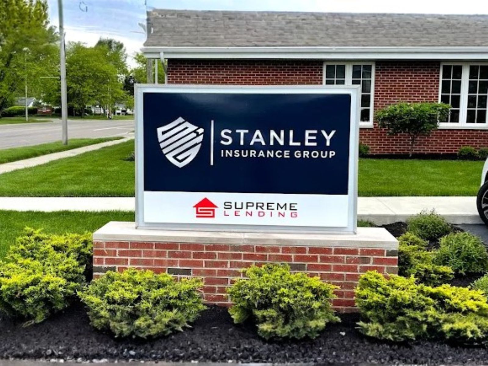 Three people at a table discussing documents with charts and a coffee cup.
