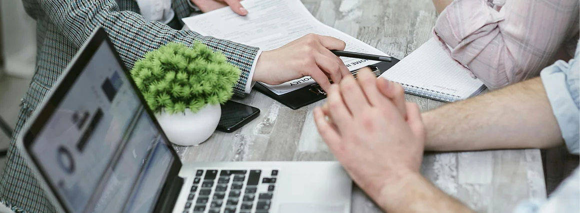 Independent insurance agent meeting warmly with clients in an office setting Independent insurance agent meeting warmly with clients in an office setting