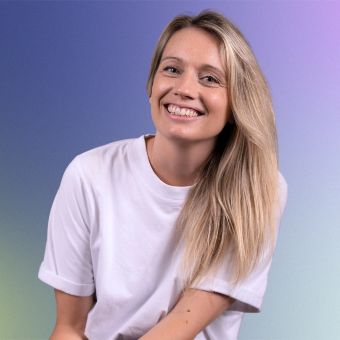 A woman with blonde hair and a white shirt.