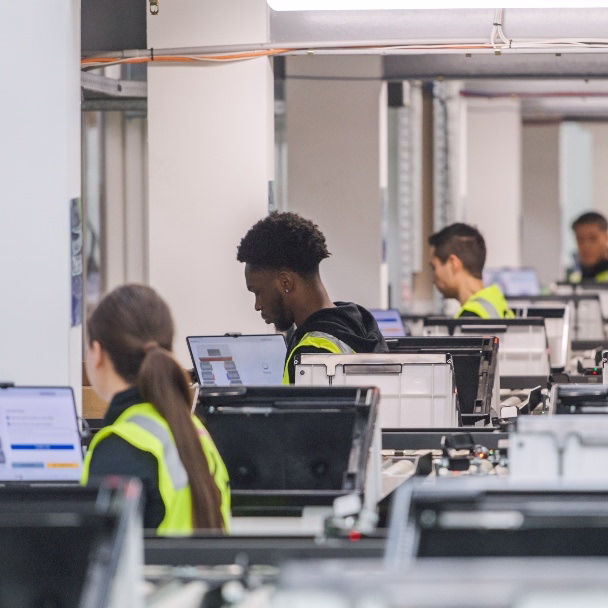 Team at Sydney 3PL warehouse performing quality checks and order processing at computer workstations.