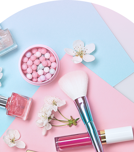 A pink and blue table with a variety of makeup and nail polish.