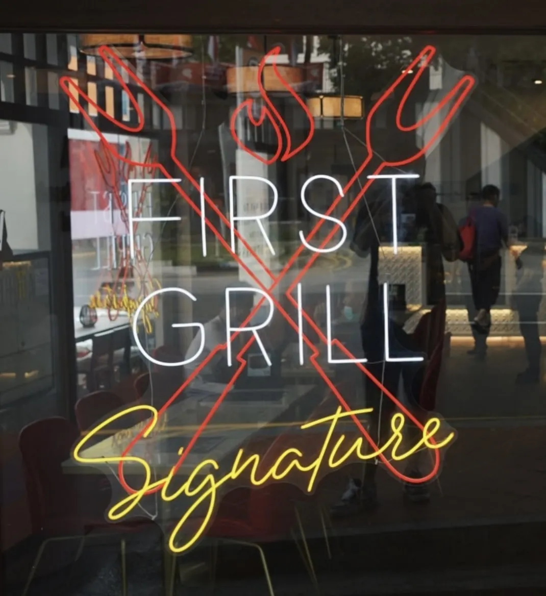 First Grill Singapore Logo on store exterior window panel