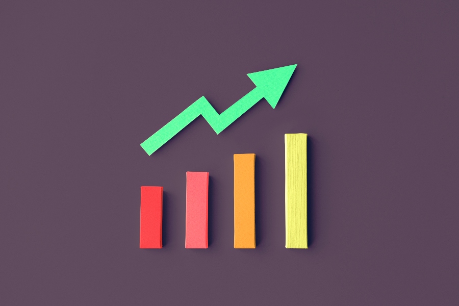 A green arrow pointing upward with three colored blocks underneath it.