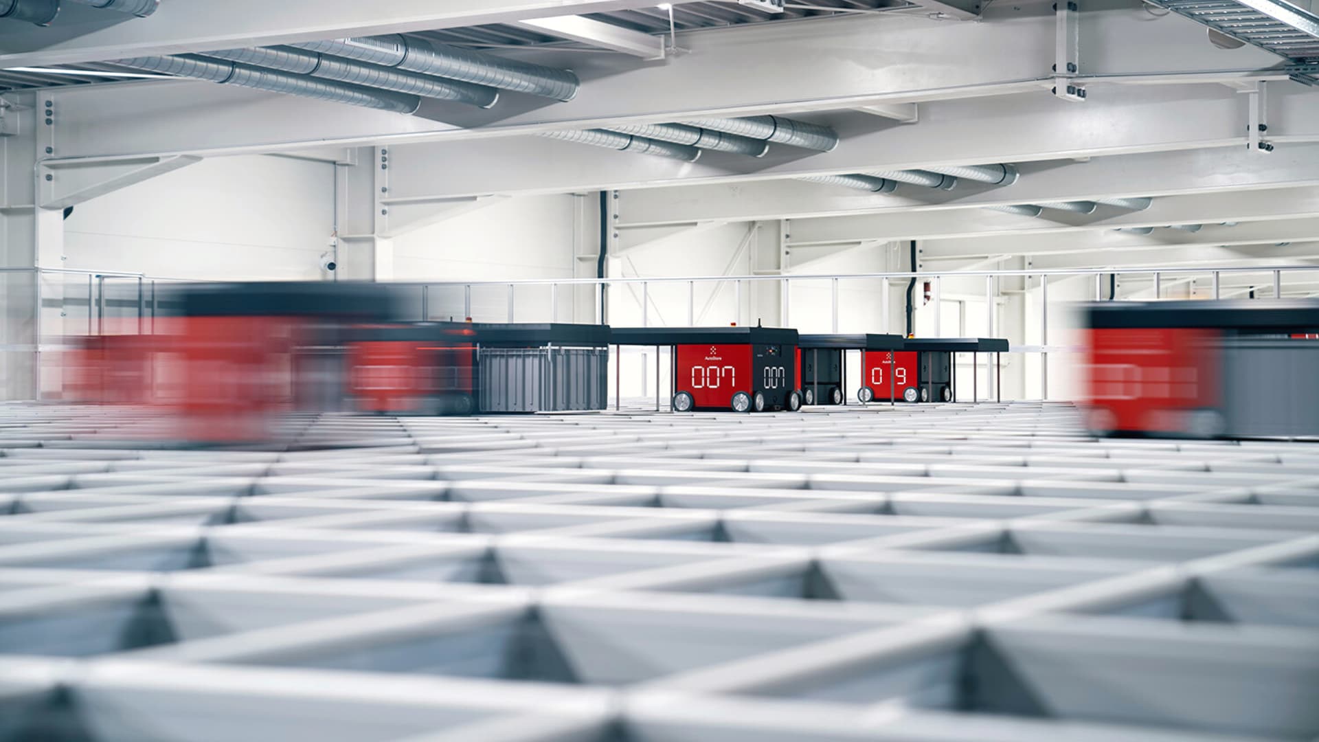 A large white building with a red train inside.