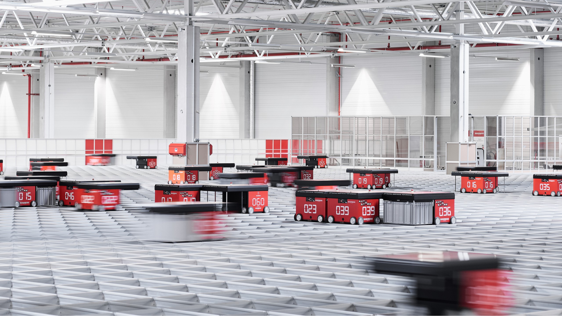 A red robotic vehicle in a warehouse.
