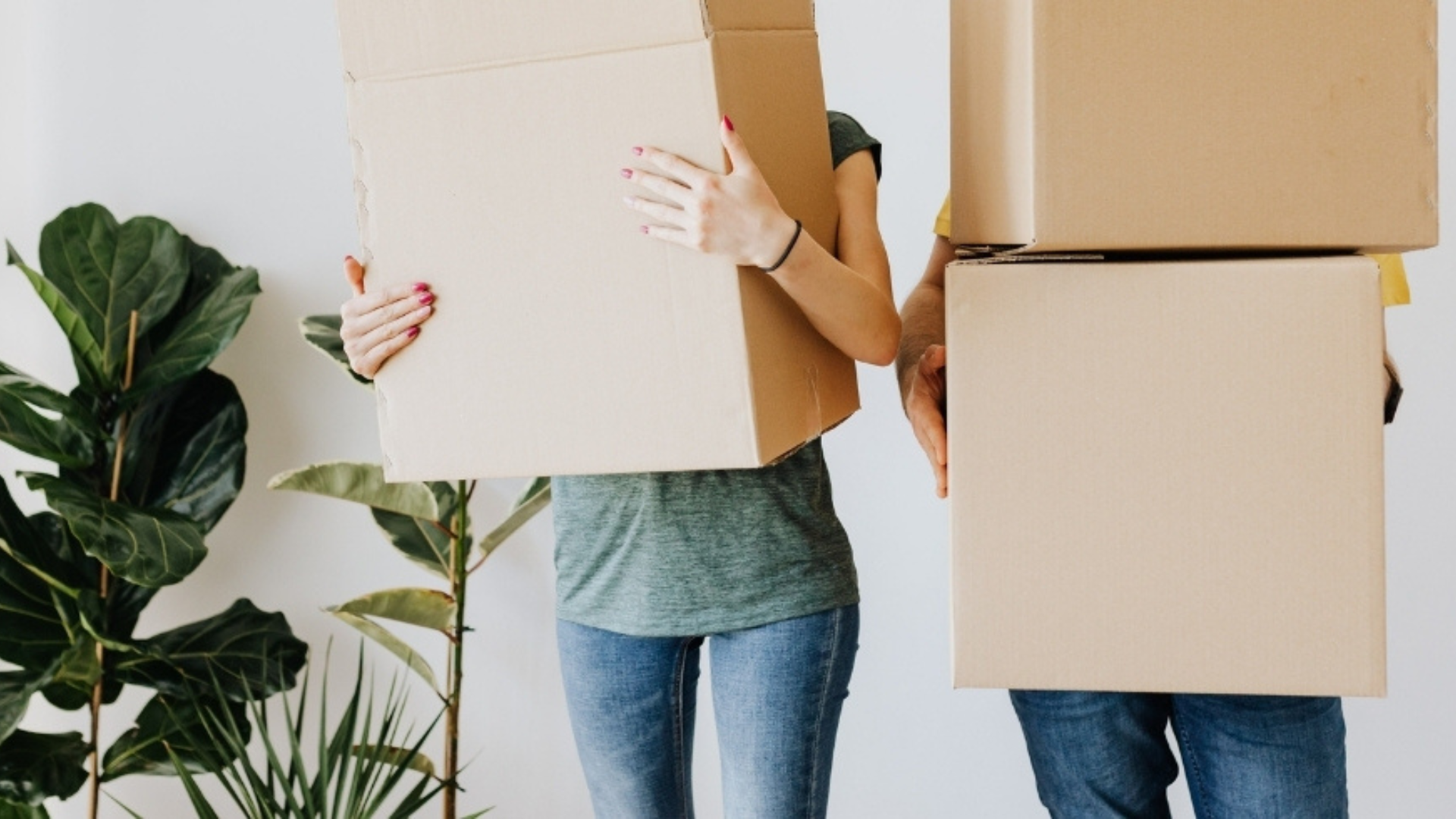 Two people holding boxes in front of them.