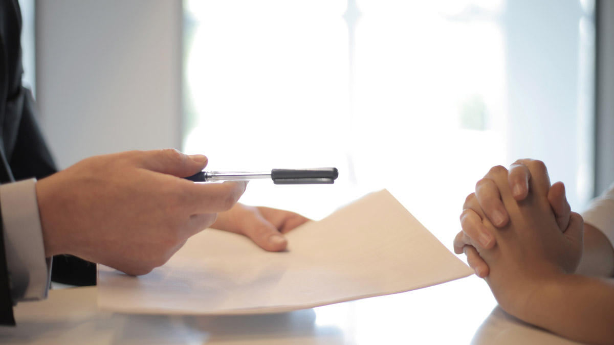 A person is writing on a piece of paper.