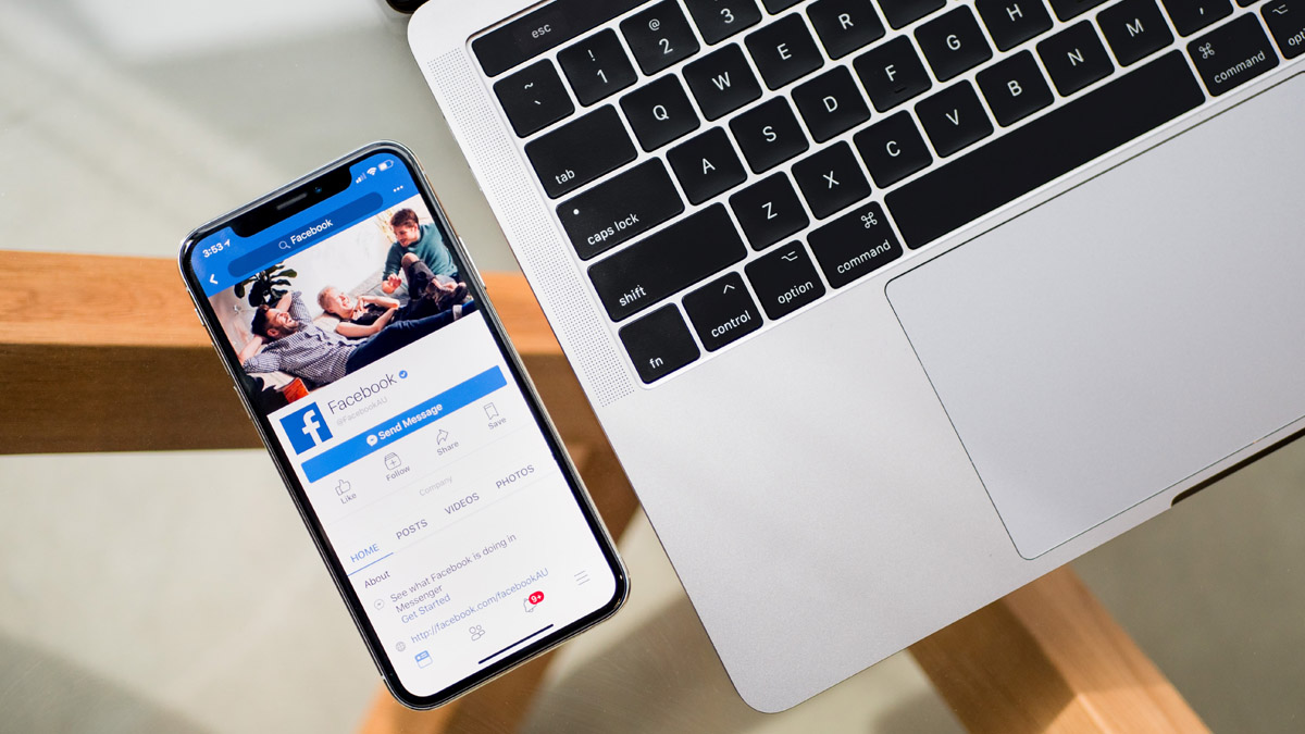 A cell phone with a Facebook app on the screen.