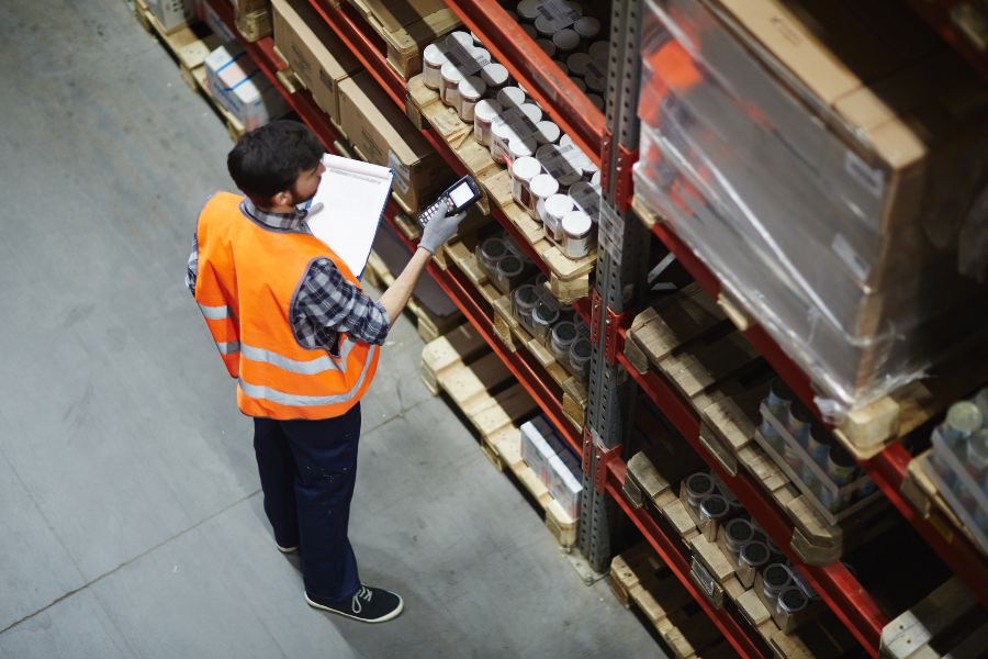 Employee checking product SKU label for inventory accuracy, showing how SKUs work in retail tracking.