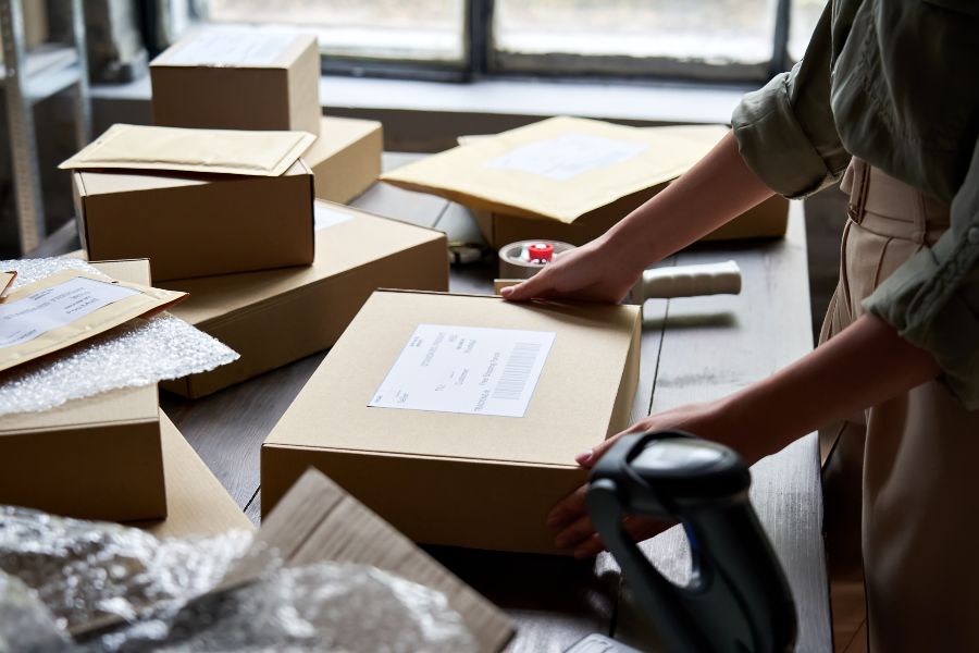 Boxes being prepared for shipping, symbolising business growth and fulfilment cost savings.
