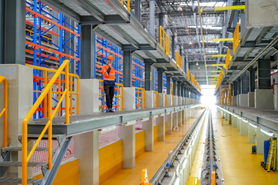 Engineer inspecting high-density racking system relevant to AutoStore vs AMR warehouse comparison