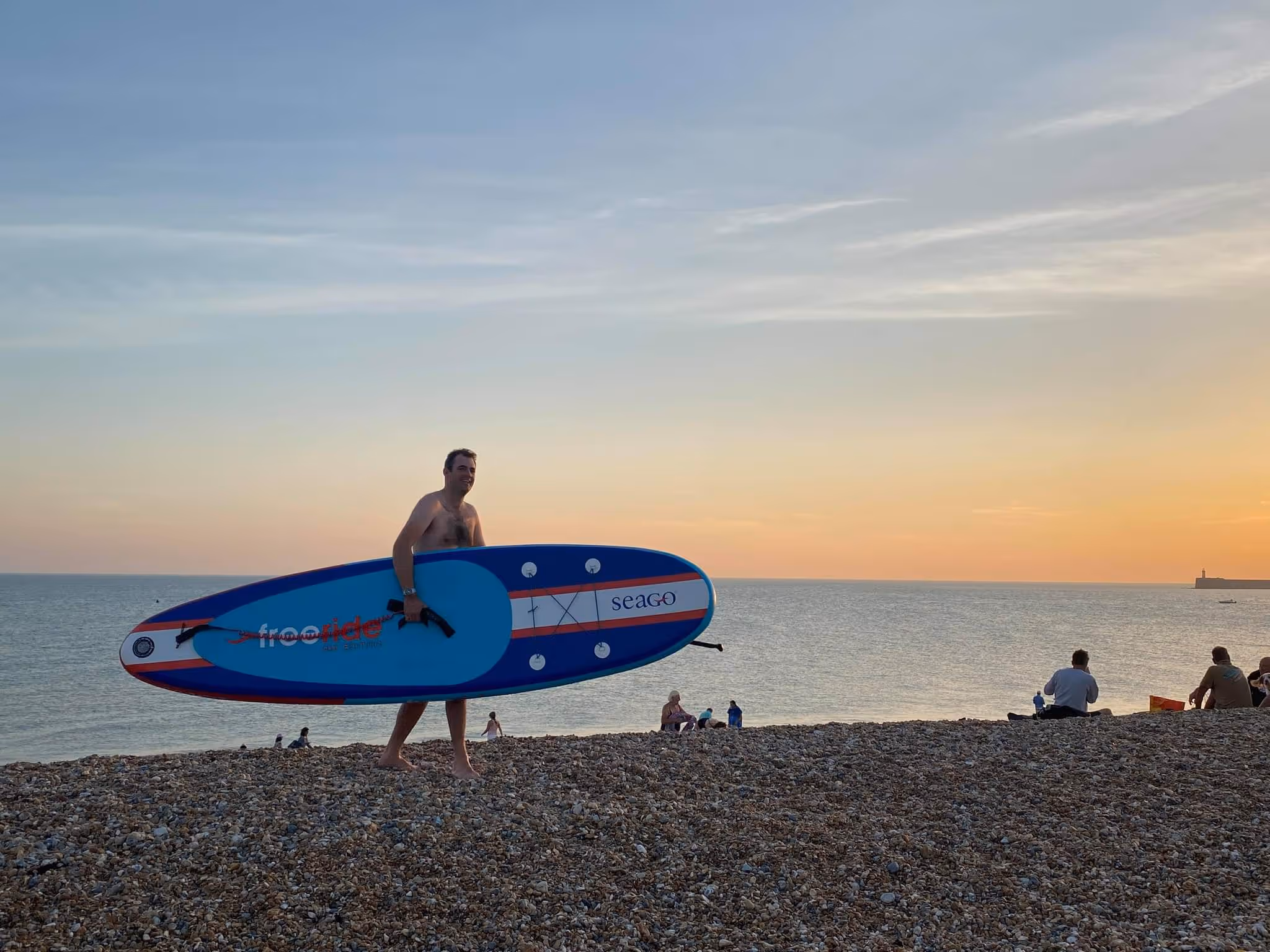 a person carrying a surfboard on a beach