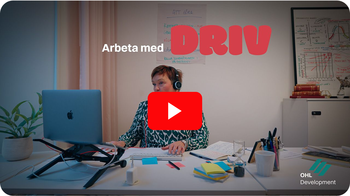 A person sitting at a desk with headphonesDescription automatically generated