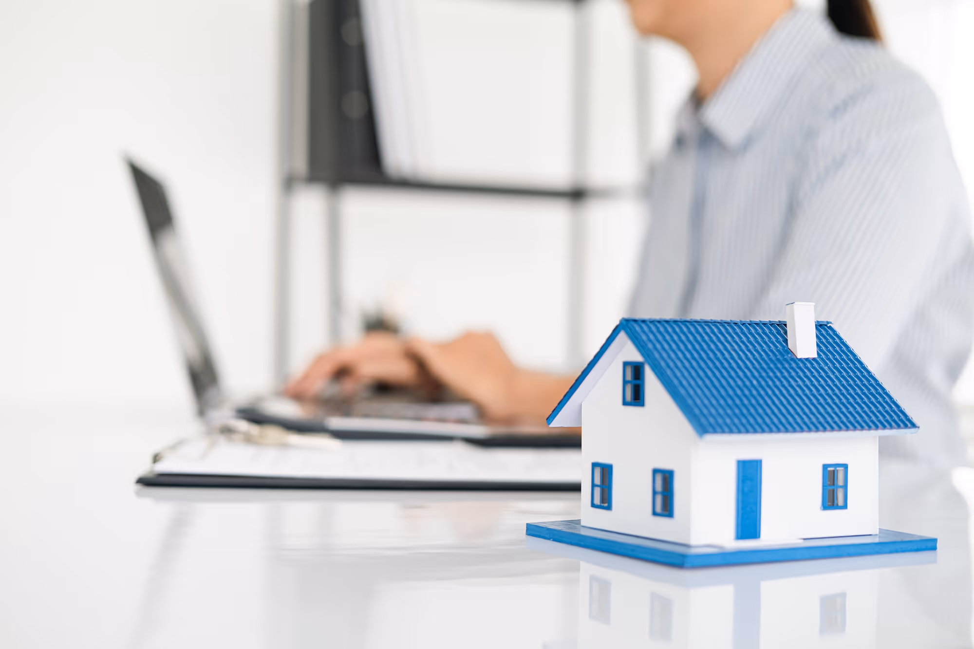 Blog post thumbnail: 6 Ways Mortgage Companies Can Be More Strategic With Email - Real estate agent working with laptop