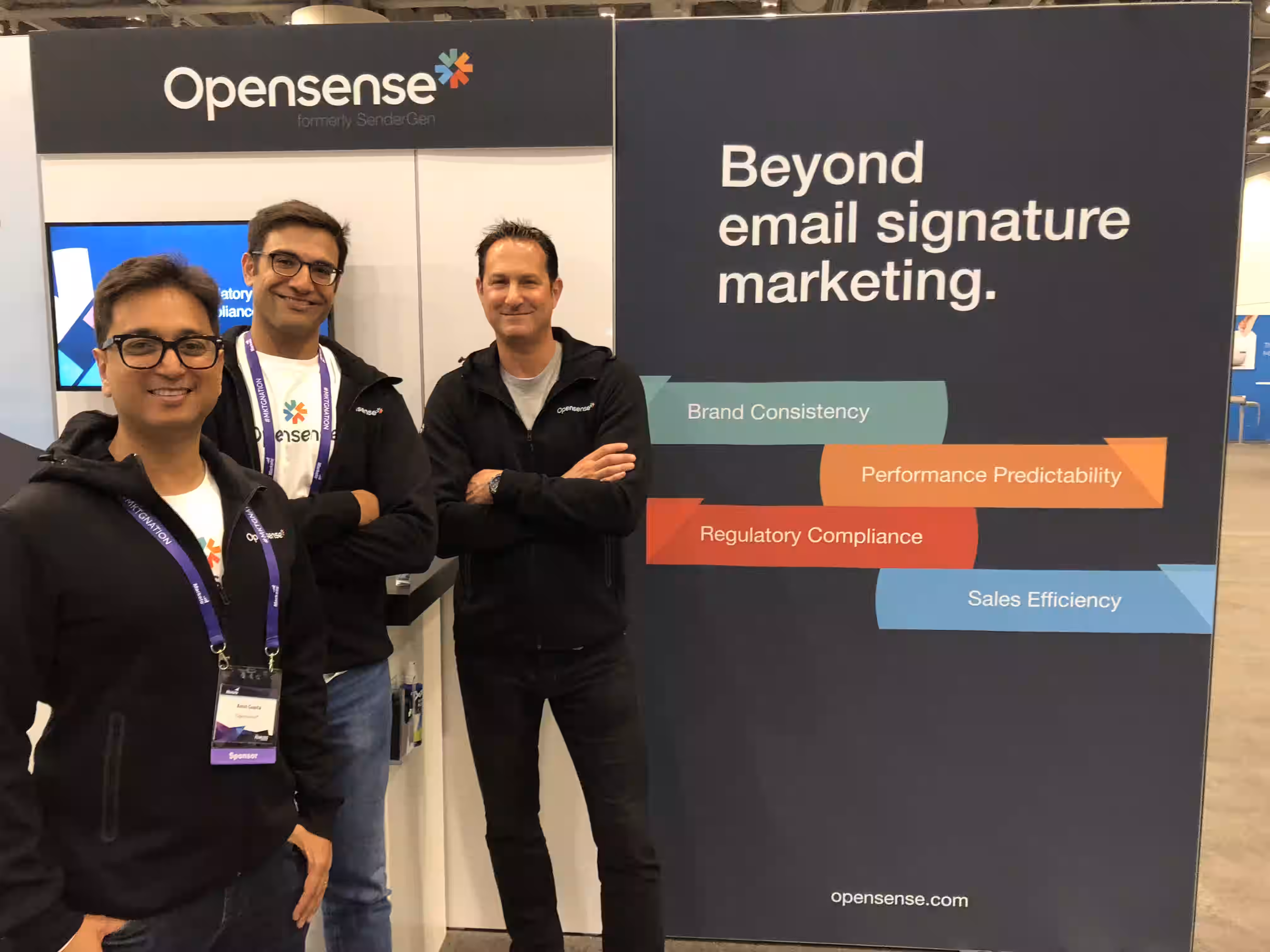 Opensense founders standing in front of their event booth.