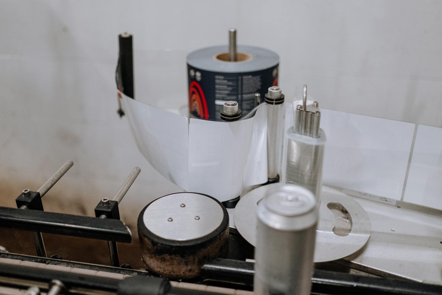 Modern conference room table with sustainable packaging samples including PET bottles with rPET labels and flexible pouches
