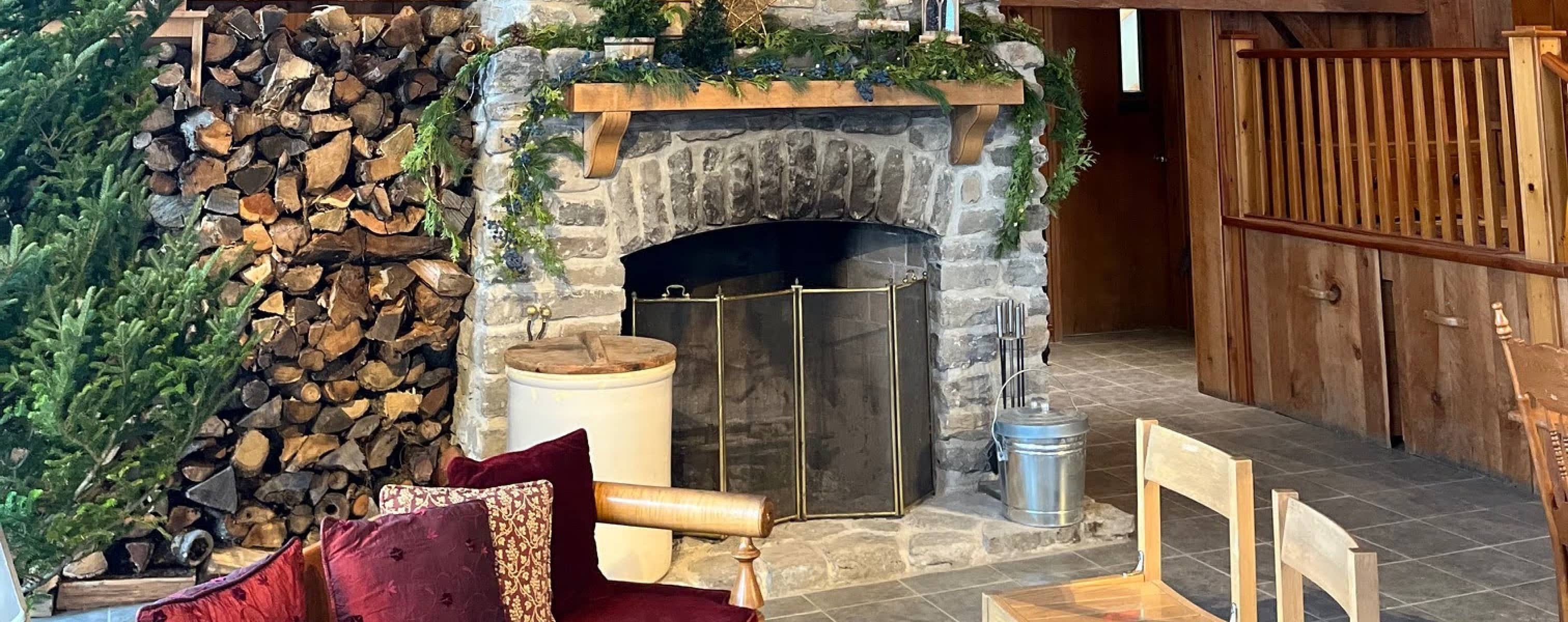 A cozy winter fireplace scene with couch and christmas tree