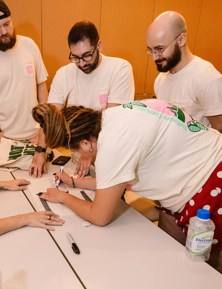 Distru teammates working through a team challenge together at a table during the Tulum offsite