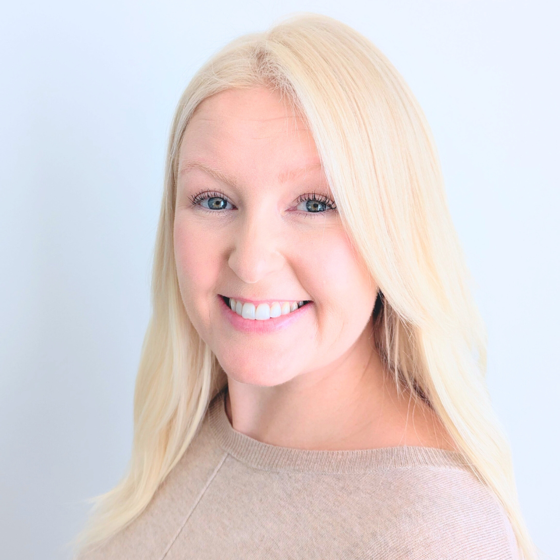 Headshot of Louise in a pink shirt and blonde hair