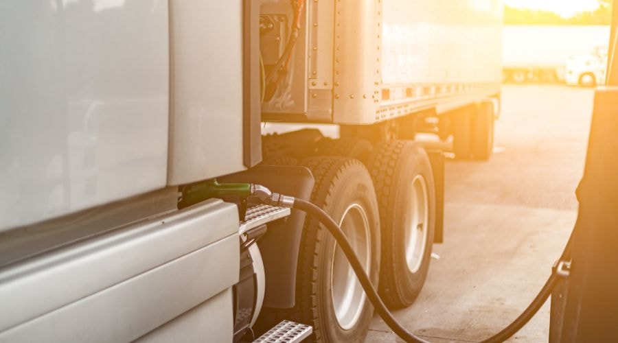 Semi-truck refueling at a gas station.