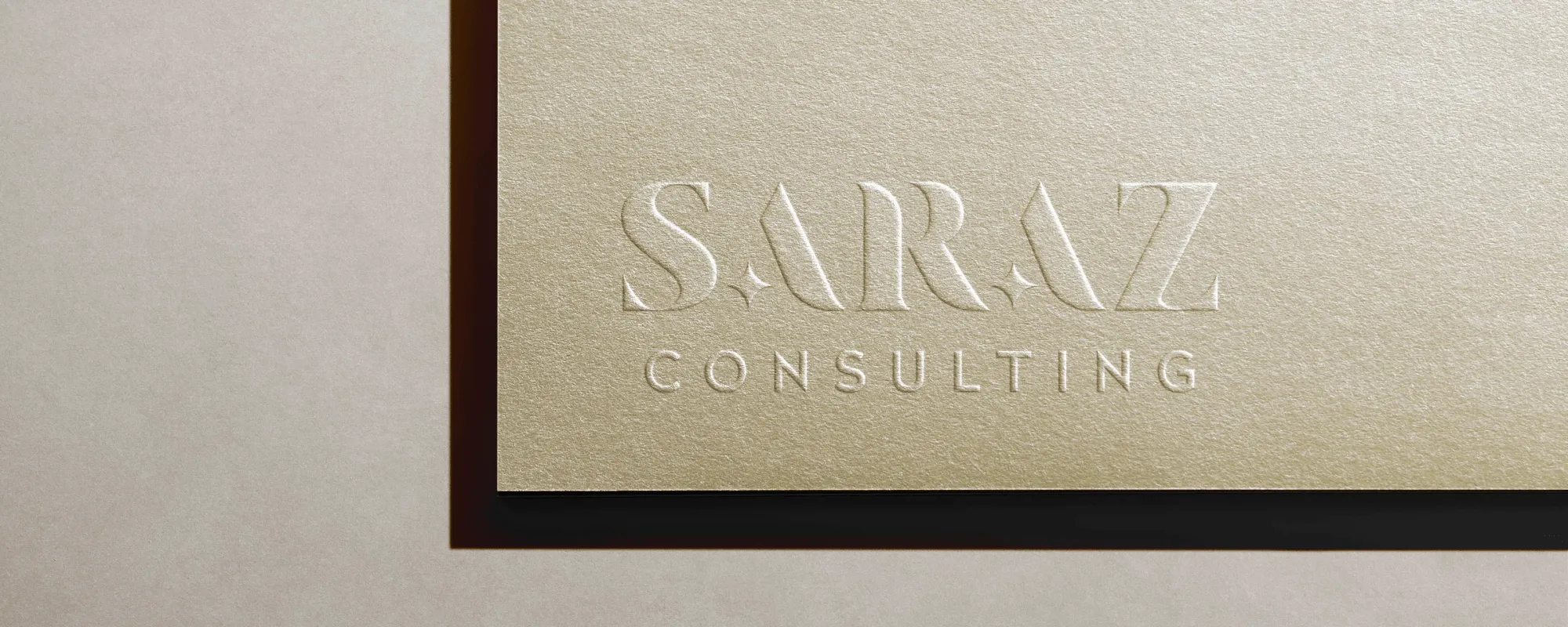 Gold paper with Saraz's logotype embossed in the corner of the paper.