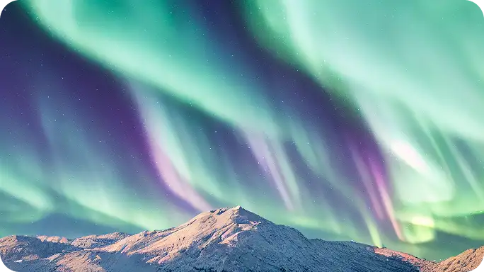 Woman with eyes closed, hands over her chest, standing peacefully outdoors with sunlight in the background.