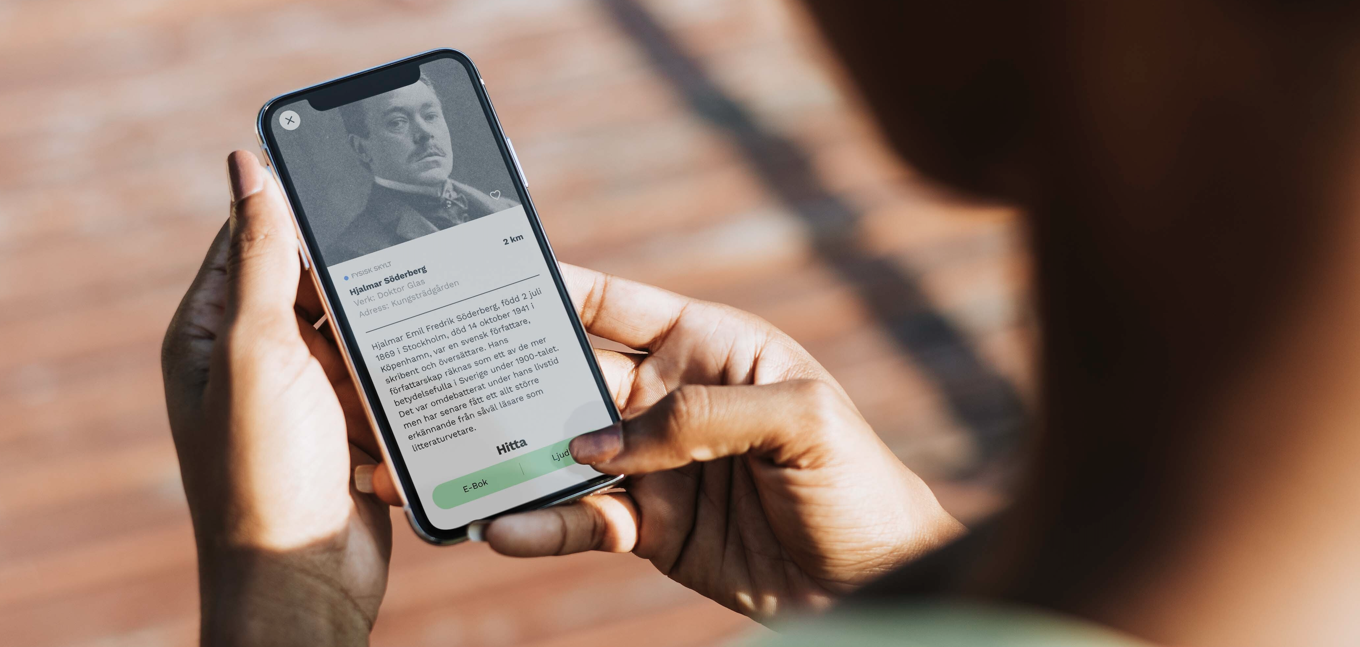 Person holding an Iphone showing the Vägvisaren app.