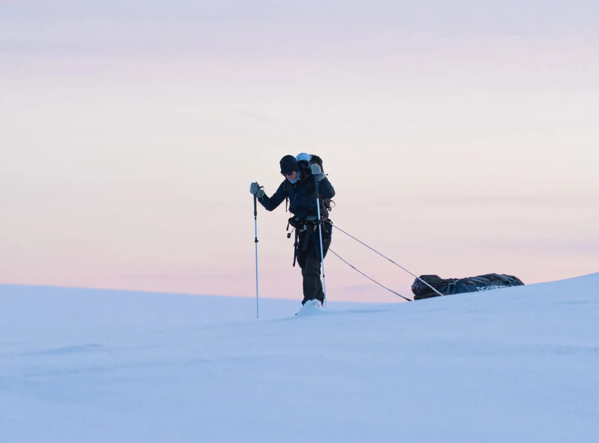 Girl on touring skis in clothing for a winter camping expedition