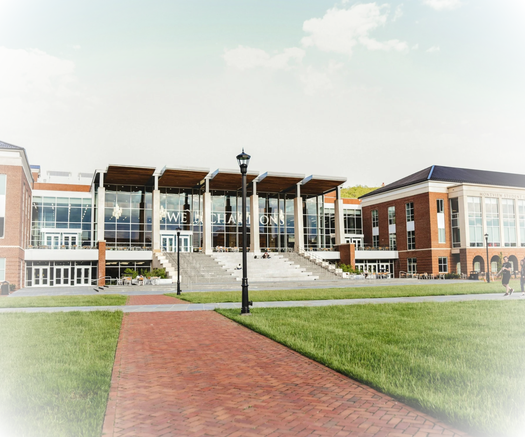 2 images, one being the Exterior view of a modern brick school building and  2 being Three smiling high school students posing in front of a photo booth setup in a classroom 