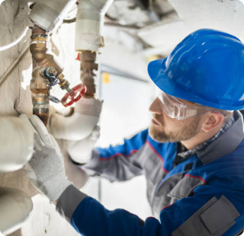 Professional plumber fixing commercial pipes