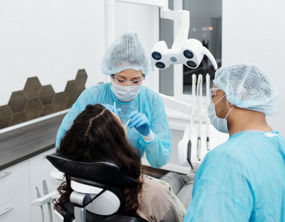Dental team providing treatment to a patient in a modern operatory
