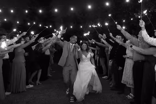 Sophie & Ben with their guests holding lights
