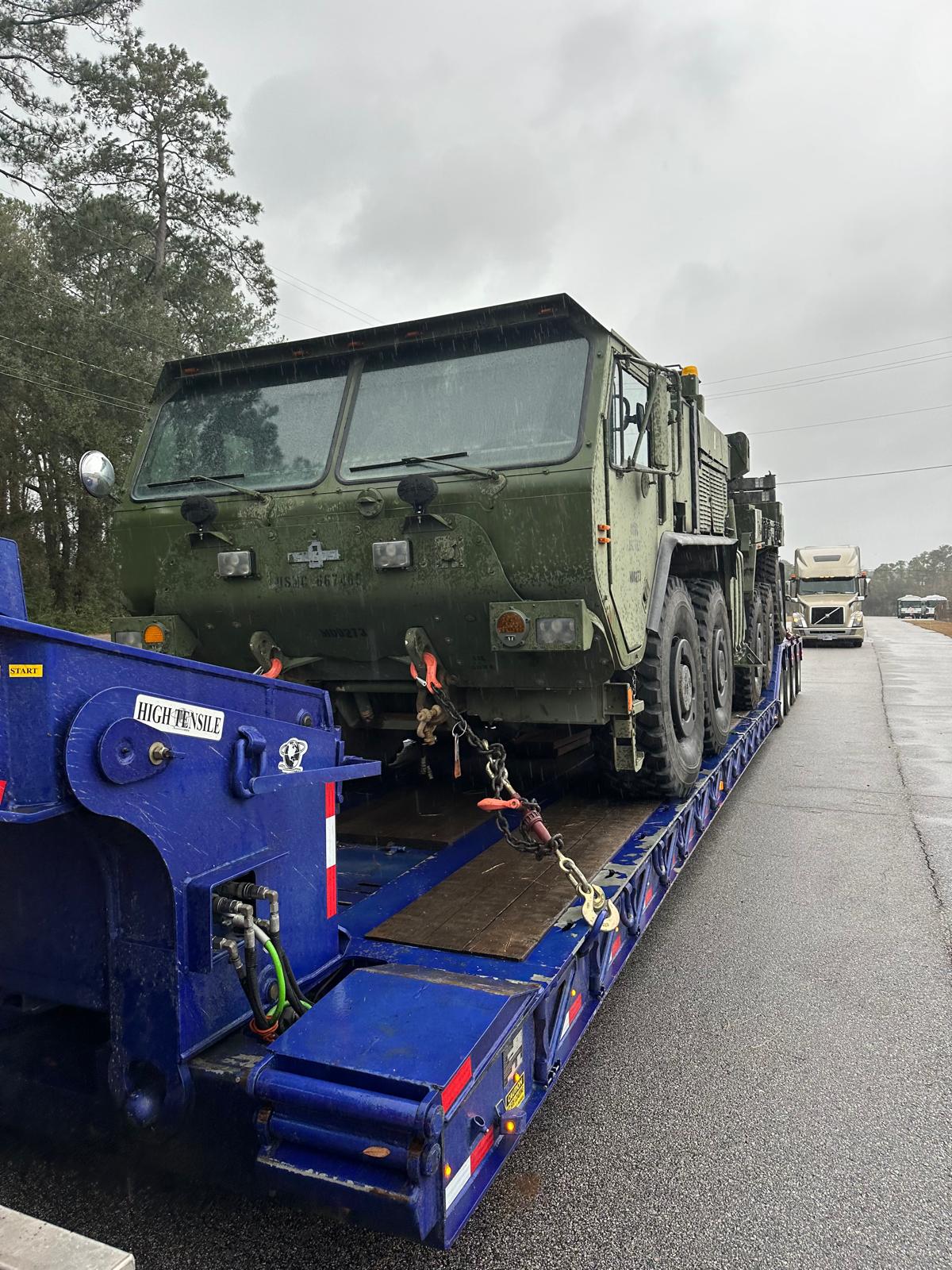 Military vehicle on an RGN truck