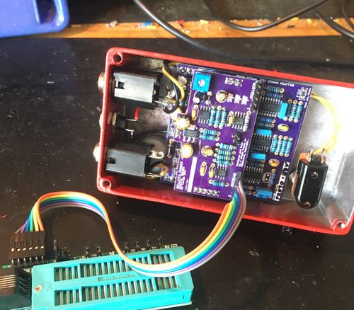 circuits inside of a red guitar pedal