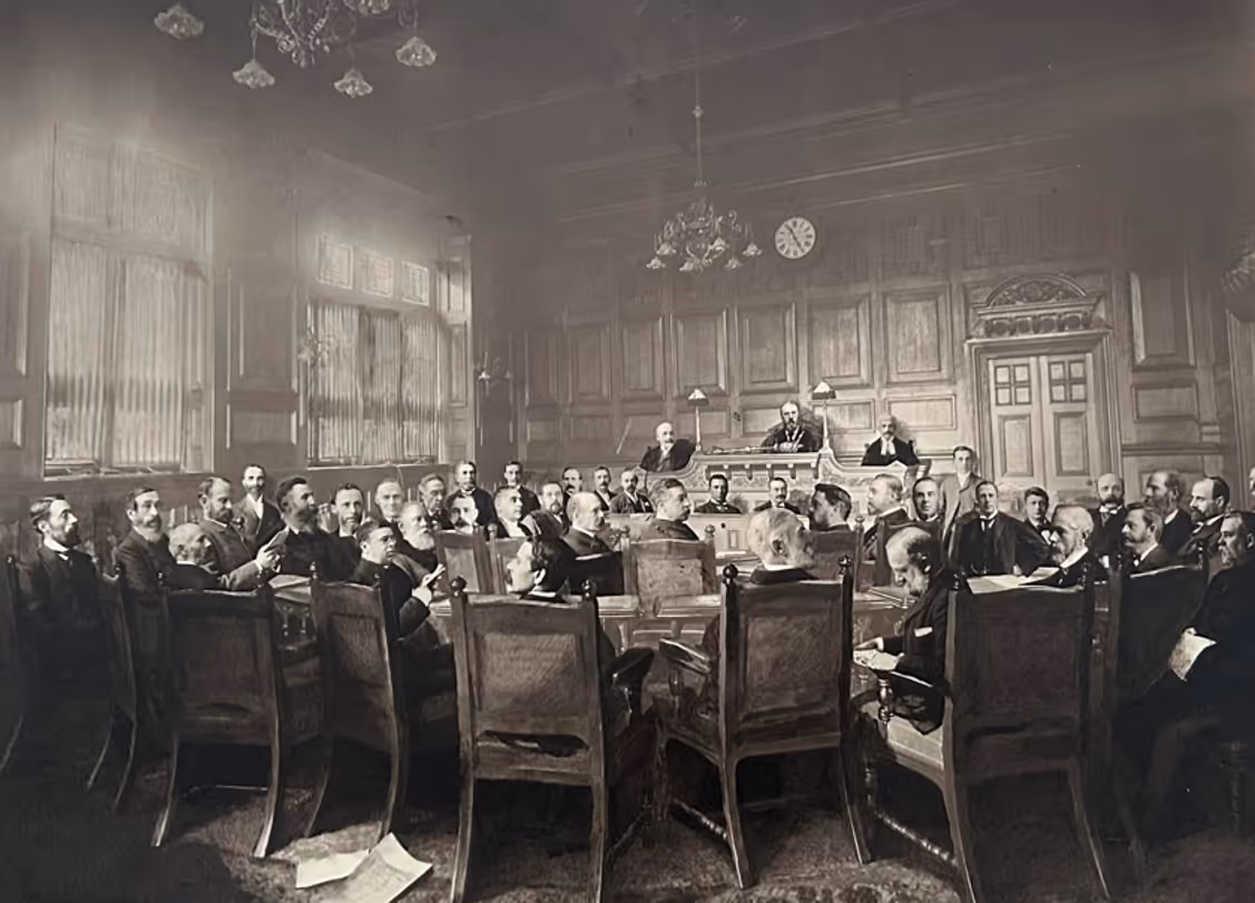 Collection of men meeting around a large table