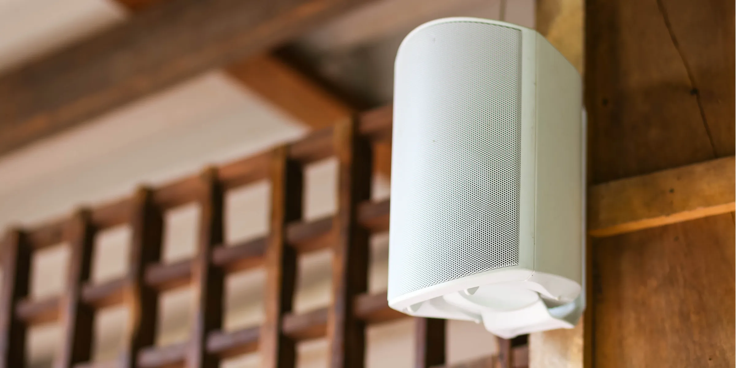 Stereo speaker connected to audio extender mounted on the wall