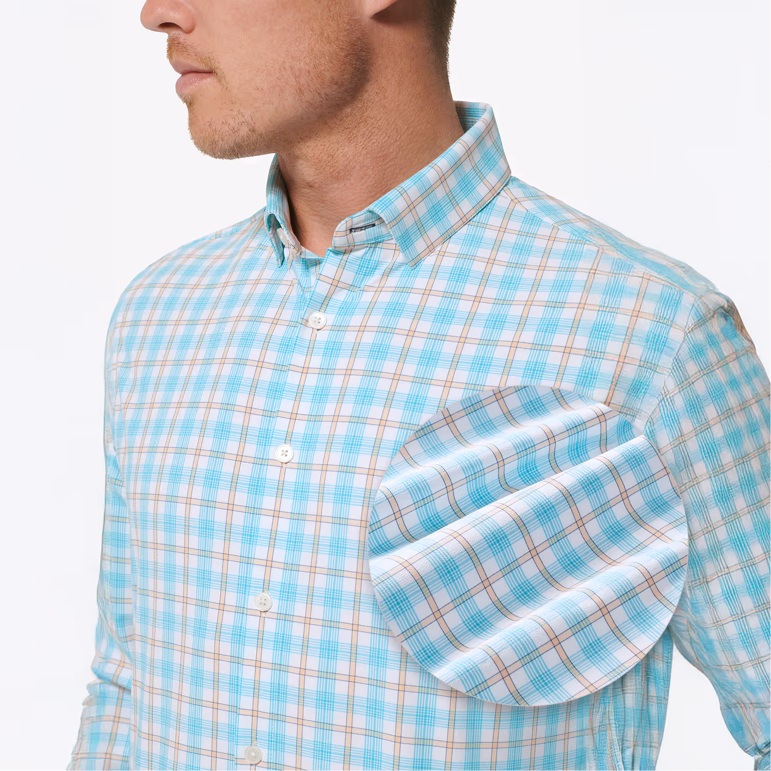 Man wearing a light blue and beige plaid button-up shirt with a close-up inset showing the fabric pattern.