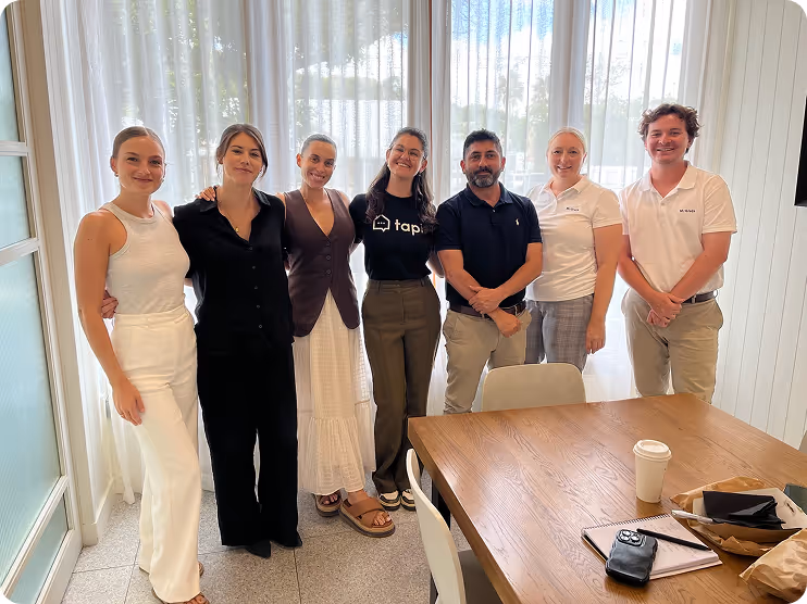 Tapi team visiting customer offices — meeting face-to-face, sharing laughs, and strengthening partnerships with property managers in their own workspace.