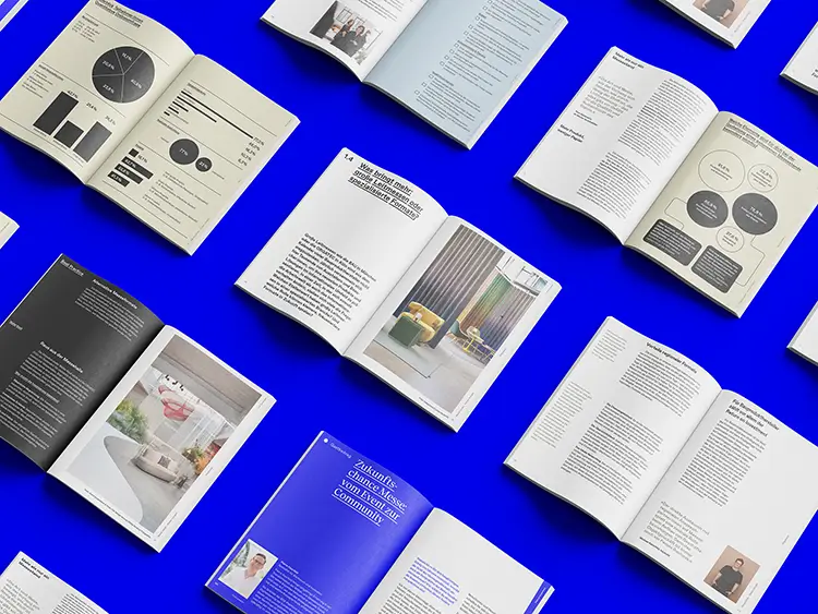 Open magazines on a blue background show inspiring layouts, graphics and texts for modern print and corporate publishing.