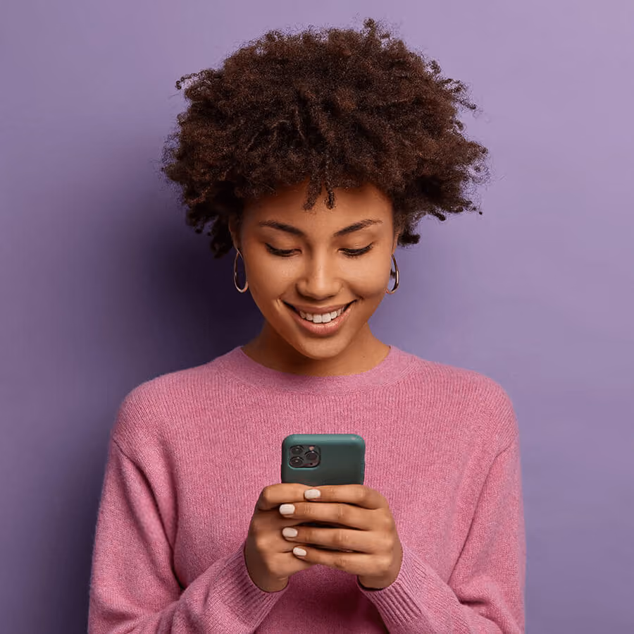 Human smiling down at phone.
