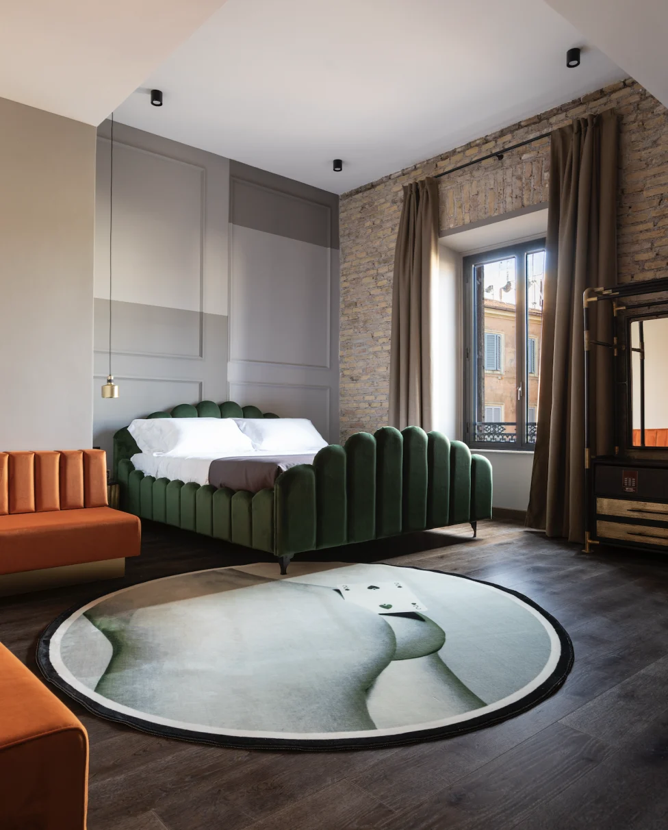 An outdoor pool with lounge chairs, beige sun umbrellas, with an infinity view of the Caribbean Sea.