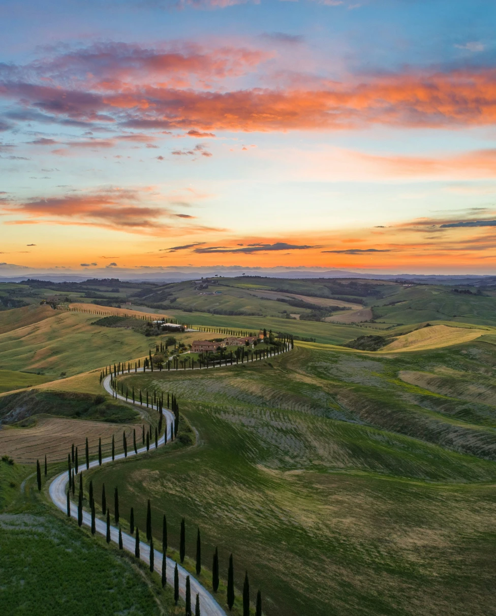 An outdoor pool with lounge chairs, beige sun umbrellas, with an infinity view of the Caribbean Sea.