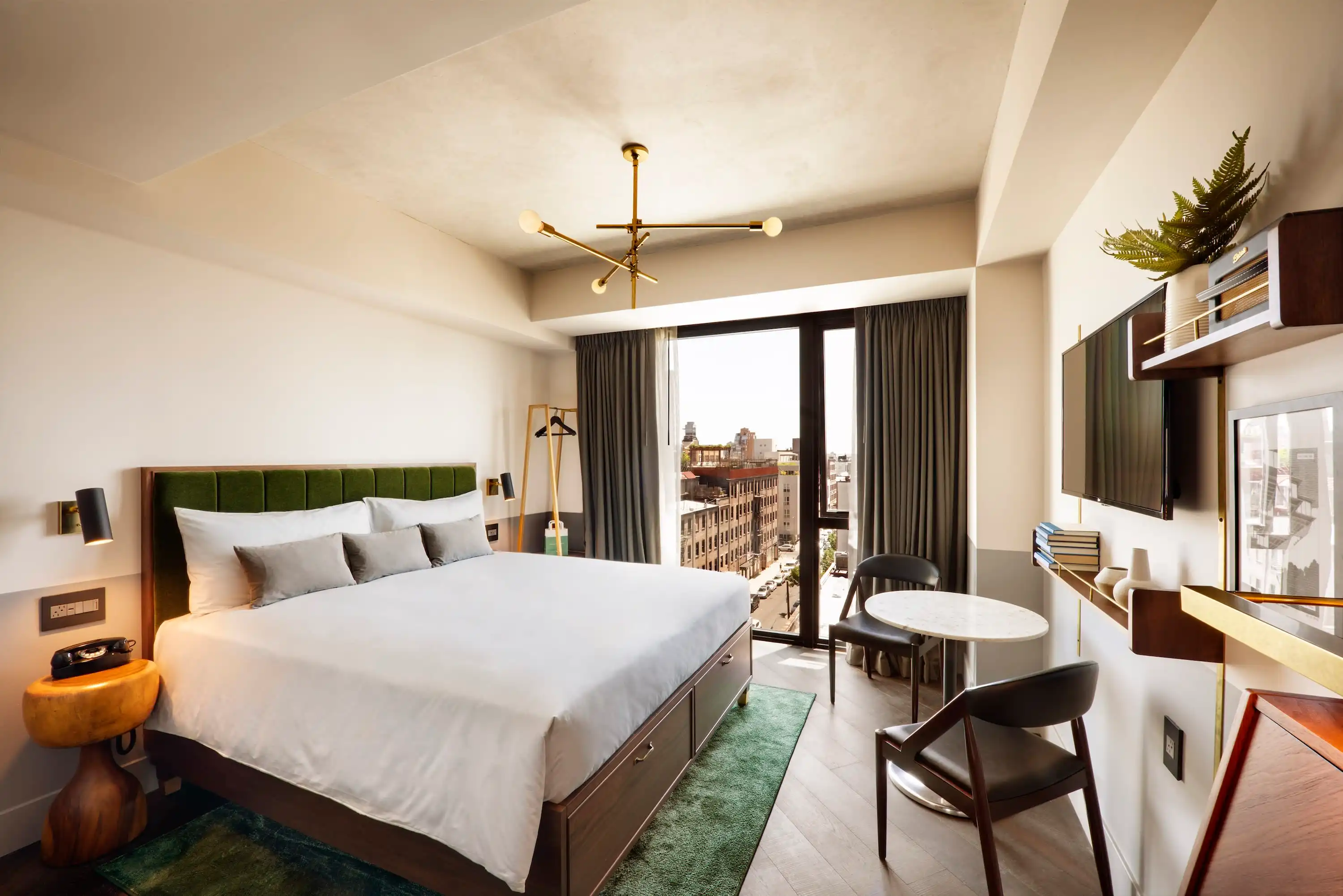 Table with white cloth and a traditional French breakfast in a suite of Hotel Lutetia in Paris, with an incredible view of the Eiffel Tower and Parisian rooftops.